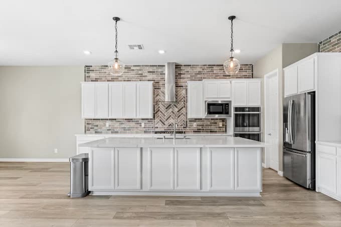 Kitchen with brick backsplash and pendant lighting
