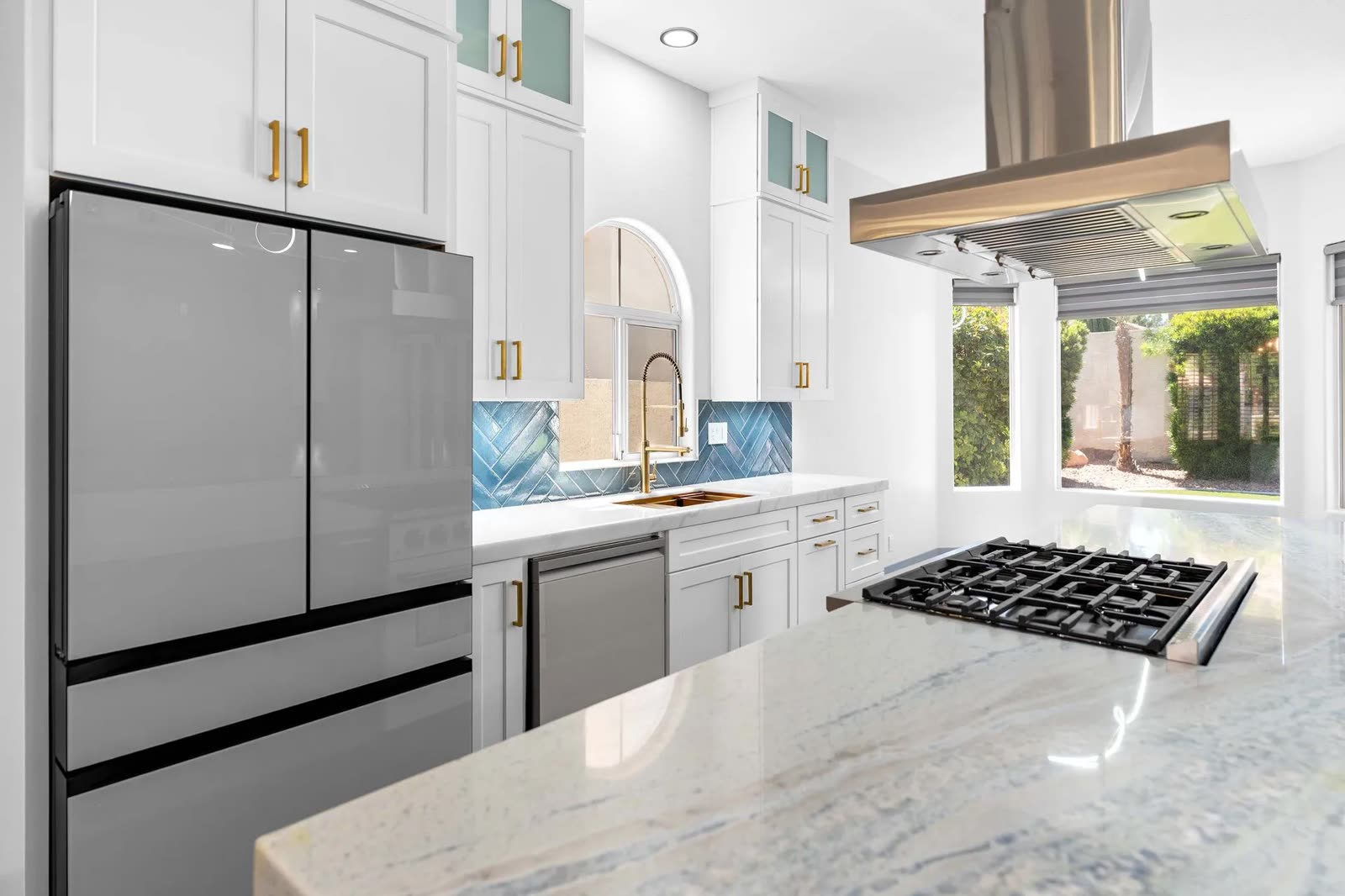 Kitchen with blue herringbone tile backsplash