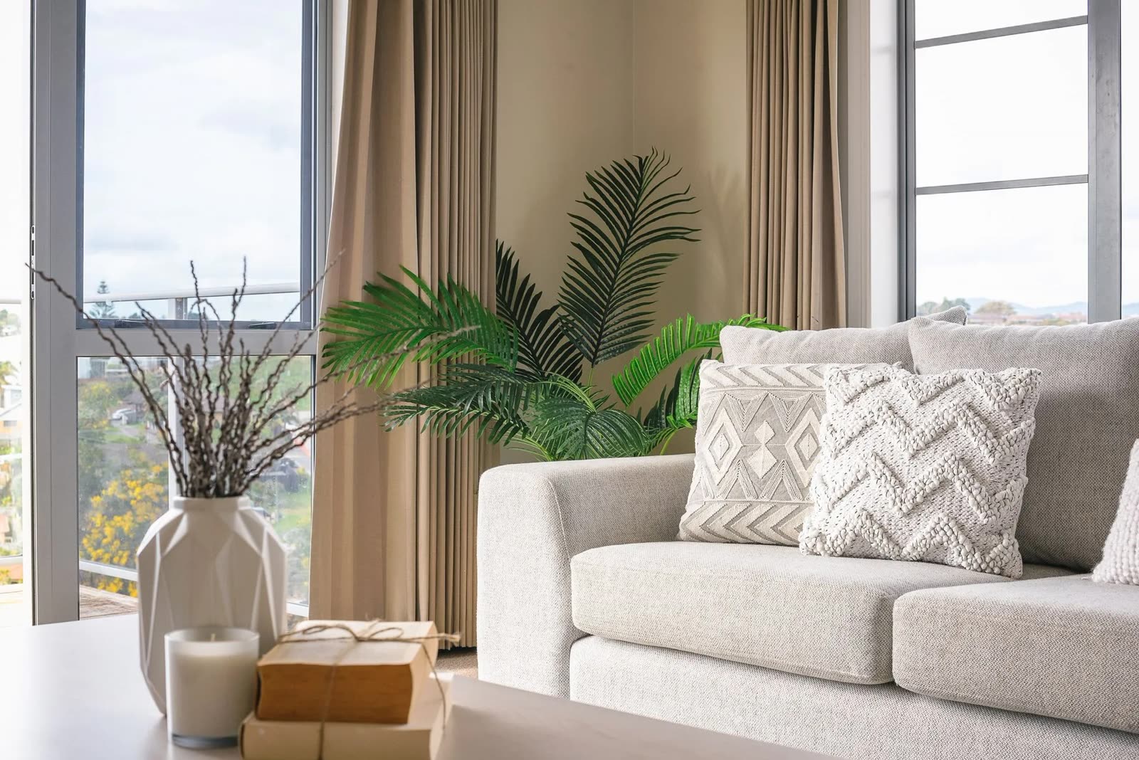 Living room corner with palm plant and styled decor