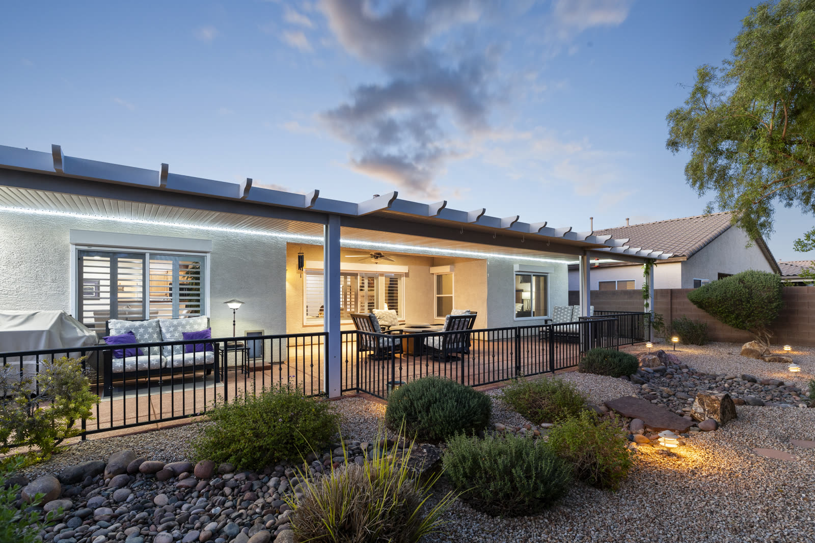 Covered backyard patio at dusk