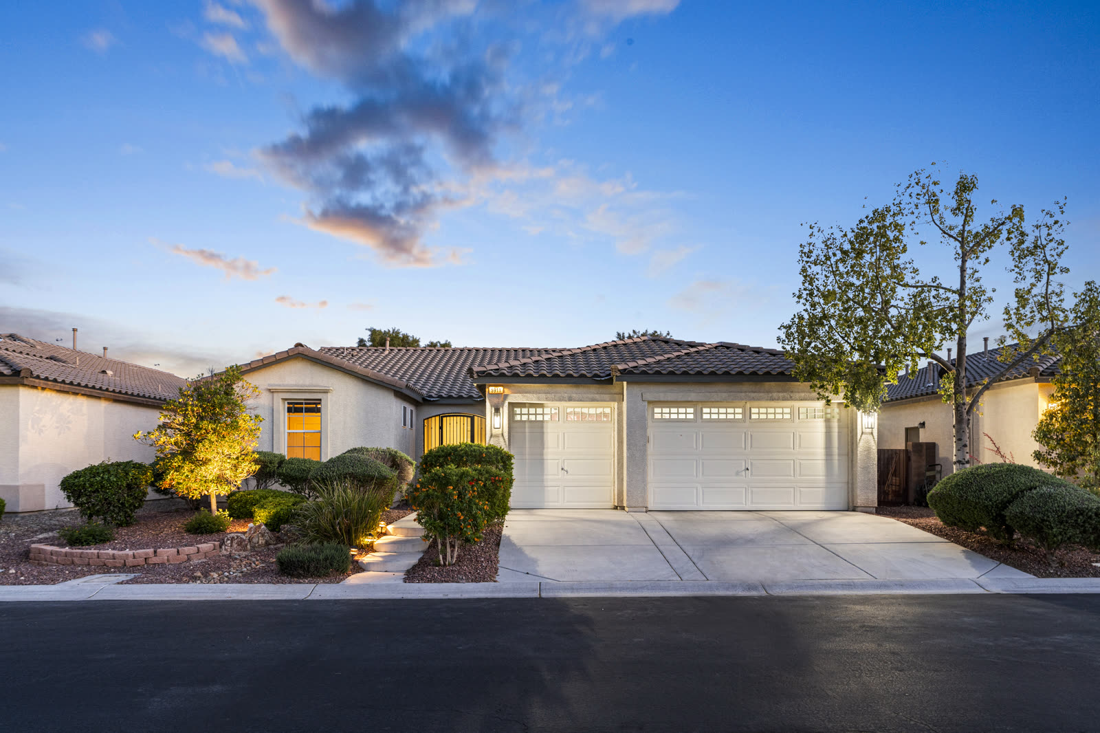 Home exterior at dusk with warm lighting